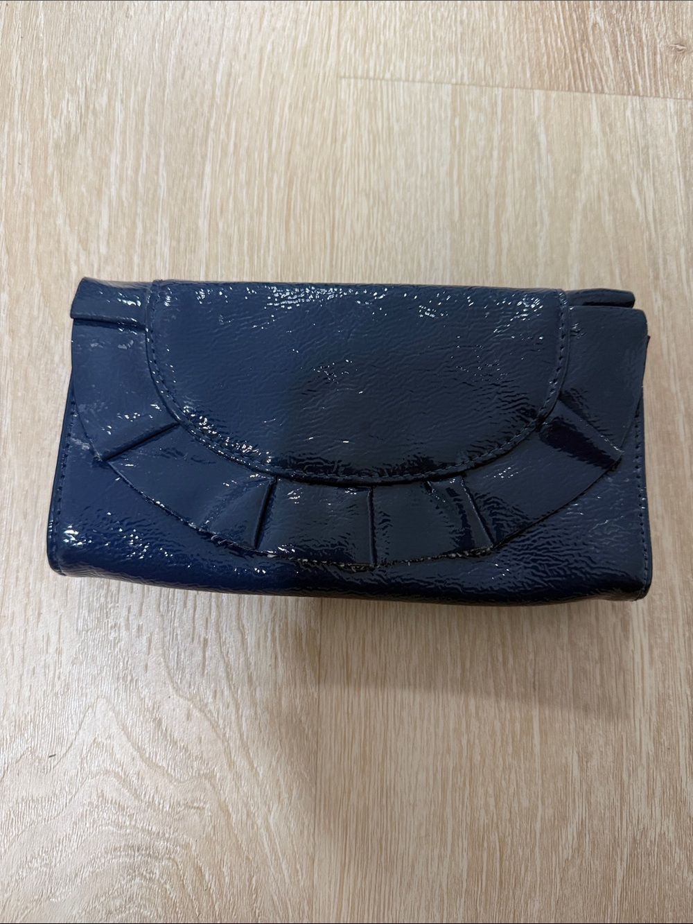 Glossy Navy Patent Clutch with Decorative Pleat Detail